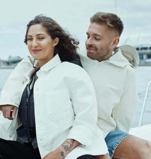 A couple laughing together on a sailboat